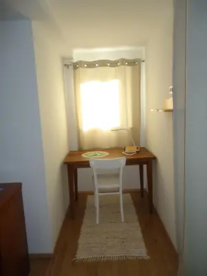 a table with a chair in a room with a window at Holiday Home Neokrnjena Narava in Sevnica