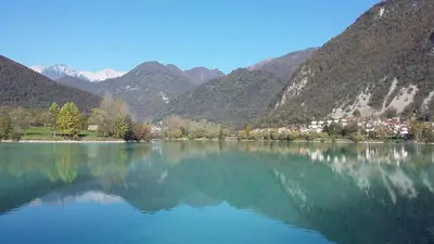 a large body of water with mountains in the background at Apartma Jezero in Most na Soči
