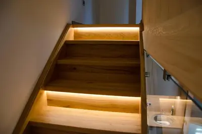 a bathroom with wooden stairs with a sink at Apartmaji Rajska Ptica in Bled
