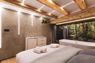 a bedroom with a large bed and a bath tub at Gami Ex-Factory Lofts in Ljubljana