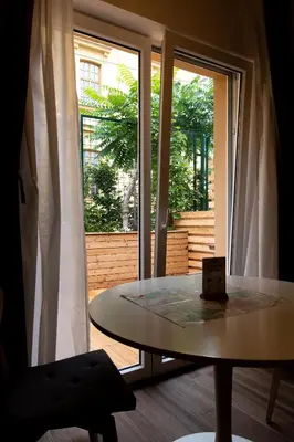 a table in front of a glass door with a window at Gami Ex-Factory Lofts in Ljubljana