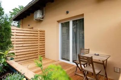 a patio with a table and chairs and a window at Gami Ex-Factory Lofts in Ljubljana