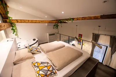 a bedroom with a large bed with two pillows at Gami Ex-Factory Lofts in Ljubljana