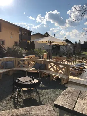 a patio with a picnic table and an umbrella at Apartments Kokl - Adults only in Radovljica