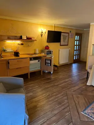 a room with a kitchen with a table and a counter at Apartments Kokl - Adults only in Radovljica