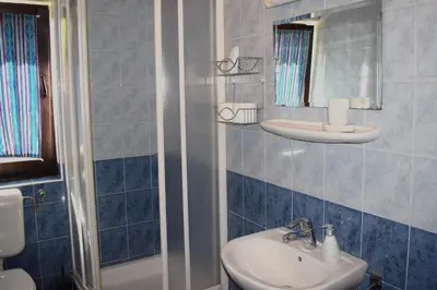 a bathroom with a sink and a toilet and a mirror at Farm Stay Zevnik in Brežice