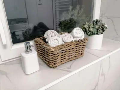 a basket of towels sitting on a bathroom counter at Apartment Mario in Ptuj
