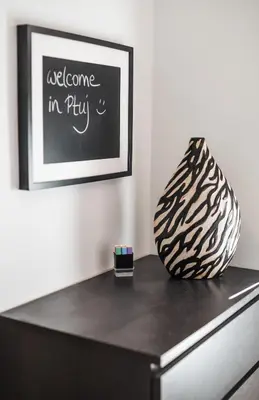 a table with a vase on top of a dresser at Apartment Mario in Ptuj