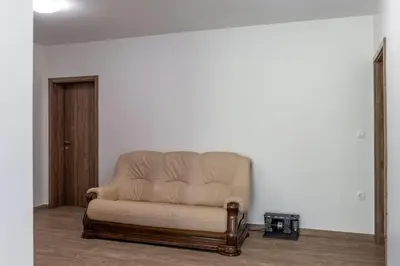 a brown leather couch sitting in a room at Vila Marin Miler in Prevalje