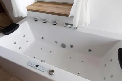 a white bath tub in a bathroom with a window at Vila Marin Miler in Prevalje