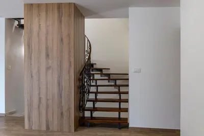 a staircase in a house with a wooden wall at Vila Marin Miler in Prevalje