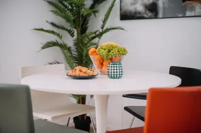a table with a bowl of fruit and a plate of food at Hanna's suite with free parking in Ljubljana