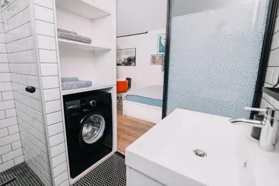 a laundry room with a washing machine in a bathroom at Hanna's suite with free parking in Ljubljana