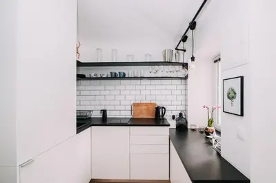 a kitchen with white walls and black countertops at Hanna's suite with free parking in Ljubljana