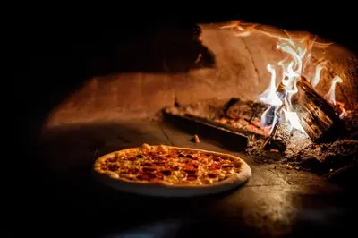 a pizza is cooking in an oven at Rooms VERDE in Petrovče