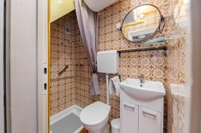a small bathroom with a toilet and a mirror at Apartma Franko in Cerklje na Gorenjskem