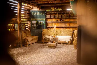 a living room with couches and a table in a building at Panorama Glamping Visole in Slovenska Bistrica