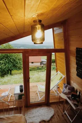 a room with a large window and a table and chairs at Panorama Glamping Visole in Slovenska Bistrica