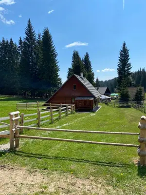 a wooden fence in front of a barn at Cosy Chalet on Pokljuka - Brunarica Tinkara in Zgornje Gorje