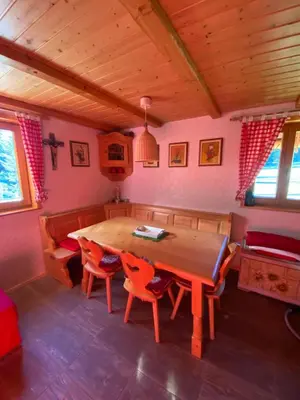 a dining room with a wooden table and chairs at Cosy Chalet on Pokljuka - Brunarica Tinkara in Zgornje Gorje