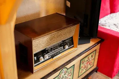 an old radio sitting on top of a dresser at Cosy Chalet on Pokljuka - Brunarica Tinkara in Zgornje Gorje