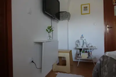 a living room with a tv on a wall at City center blue sky house in Postojna