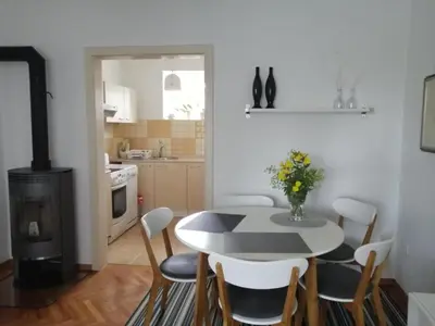 a kitchen and dining room with a table and chairs at City center blue sky house in Postojna
