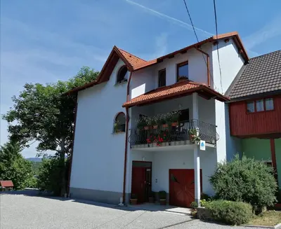 a white house with a red roof at City center blue sky house in Postojna