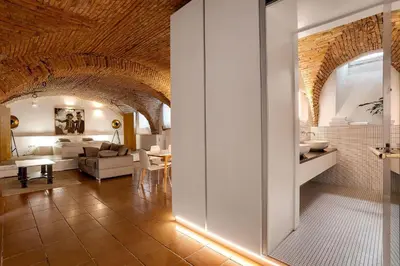 a living room with a couch and a table at Dungeon Apartment in Ljubljana