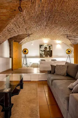 a living room with a couch and a table at Dungeon Apartment in Ljubljana