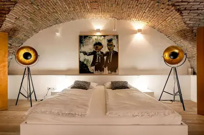 a bedroom with two beds in a room at Dungeon Apartment in Ljubljana