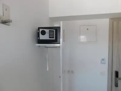 a microwave sitting on top of a refrigerator at Evi Rooms Ljubljana in Ljubljana