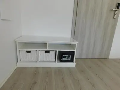 a white shelf with a microwave in a room at Evi Rooms Ljubljana in Ljubljana