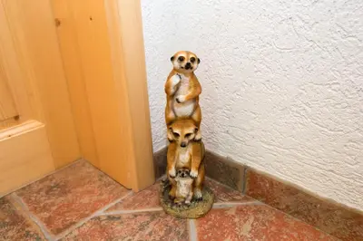 a statue of a dog standing up against a wall at Holiday Home Voje in Bohinj