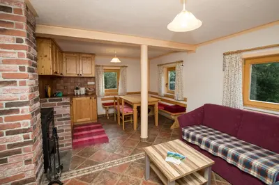 a living room with a couch and a table at Holiday Home Voje in Bohinj