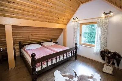 a bedroom with a bed with a wooden ceiling at Holiday Home Voje in Bohinj