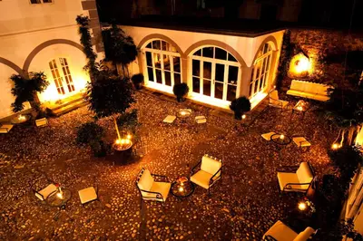 an aerial view of a courtyard with chairs and lights at Antiq Palace - Historic Hotels of Europe in Ljubljana