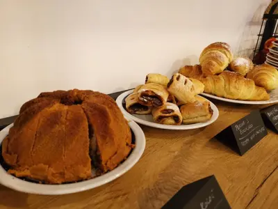three plates of bread and pastries on a table at Pri Karlu Rooms & More in Maribor