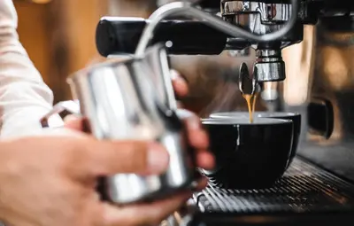 a person is making a cup of coffee at Pri Karlu Rooms & More in Maribor