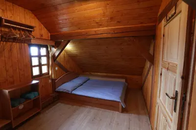 a small room with a bed in a cabin at Vineyard cottage Zidanca med vinogradi in Otočec