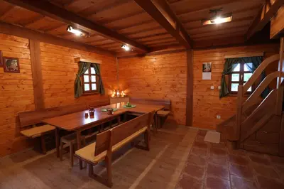 a dining room with a table and chairs in a cabin at Vineyard cottage Zidanca med vinogradi in Otočec