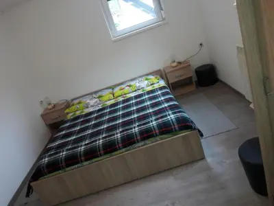 a bed sitting in a room with a window at Apartments Rozi in Bovec