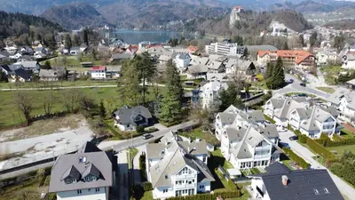 an aerial view of a town with houses and a lake at Apartments Agenija Bled in Bled