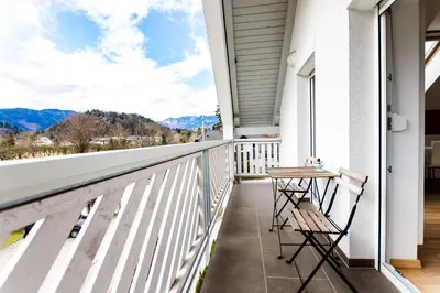 a balcony with a table and chairs on a house at Apartments Agenija Bled in Bled
