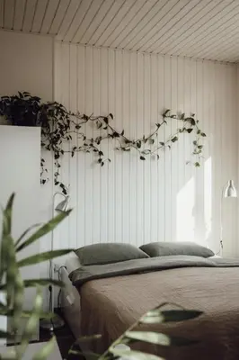 a bedroom with a bed with a flower heart on the wall at Rural Carniola fairytale in Križe