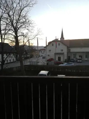 a car parked in a parking lot next to a building at Rural Carniola fairytale in Križe