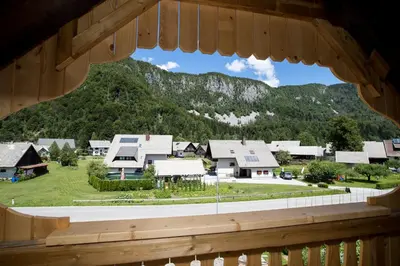 a view from a window of a town with mountains at TriSa apartments Bohinj in Bohinj