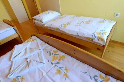 two twin beds in a room with at Apartment House Koprivnik in Zreče
