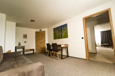 a living room with a couch and a table at Hotel Prebold in Prebold