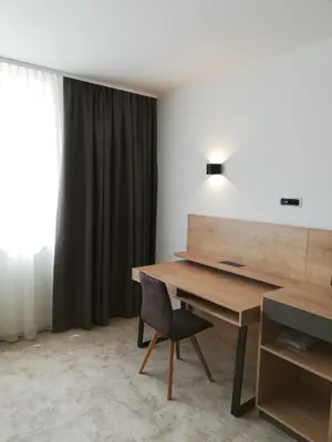 a desk and a chair in a room with a window at Hotel Prebold in Prebold